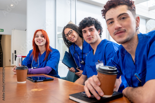 Obraz na płótnie Medical students smiling during coffee break in hospital