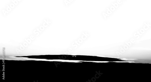 Dramatic black and white landscape of a small island surrounded by water under a vast sky