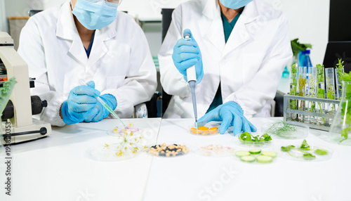Food scientists in lab coats, testing samples, and analyzing food safety and quality in a modern laboratory