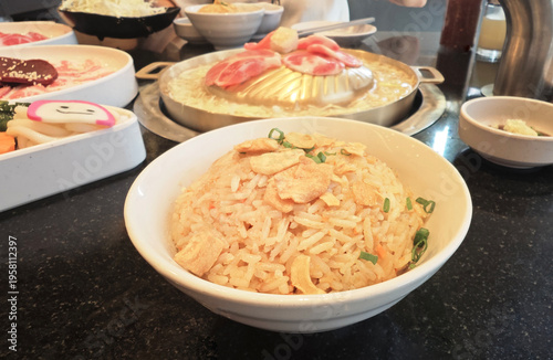 Close-up of garlic rice on a Korean-style table with side dishes, showcasing a cozy and appetizing meal scene