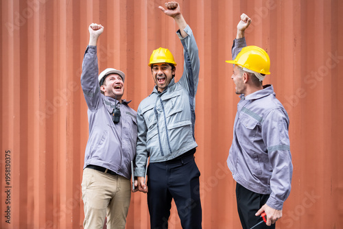 Engineer industrial workers males celebrating success in shipping container logistics teamwork