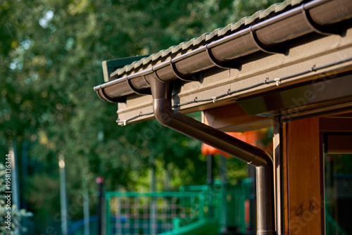 Roof line with brown gutters and wood soffit