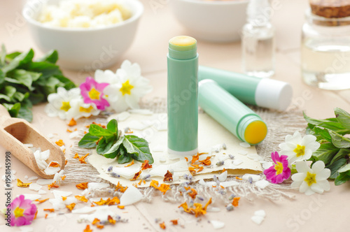 Diy lip balms, emulsifier in a wooden spoon with cosmetic ingredients, wax and shea butter in a bowl