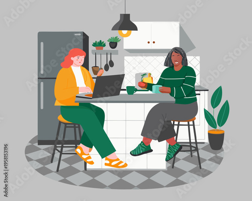 Two women connect in a bright kitchen one working on a laptop
