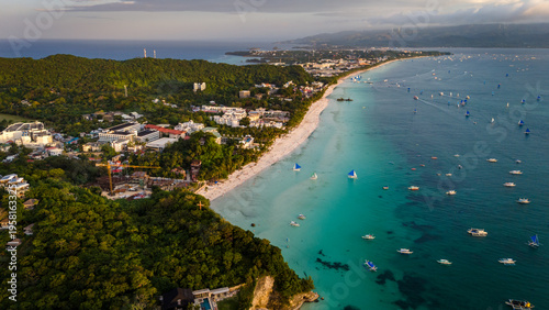 Aerial view of the world-famous White Beach in Boracay, Philippines. Crystal clear turquoise waters, white sand, and luxury resorts along the tropical coastline