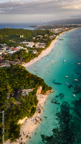 Aerial view of the world-famous White Beach in Boracay, Philippines. Crystal clear turquoise waters, white sand, and luxury resorts along the tropical coastline