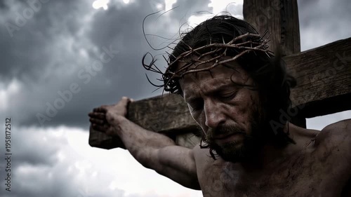 Jesus on the cross with head bowed in death against a darkening sky