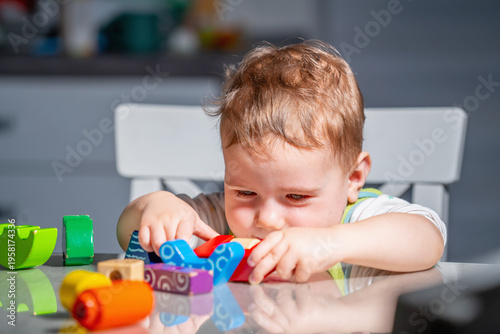 Real child immersed in stacking game, expressing focus, patience, and curiosity in a candid moment of everyday play.