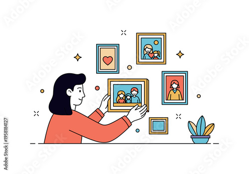 Decorating with family memories person gently placing a framed family photo on a wall while other small frames surround it. Warm visual metaphor of celebrating