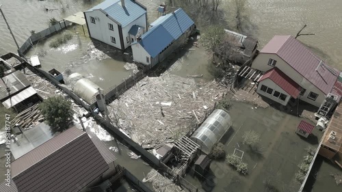 A spring large-scale flood disaster with fully submerged houses, flooded roads,and overflowing waterways. The footage shows the dramatic impact of heavy rainfall and rising water levels on residential