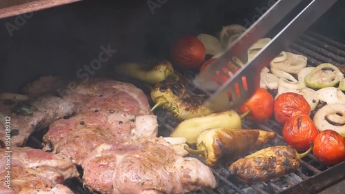 Sizzling chicken and fresh vegetables roast over a hot charcoal fire at a summer barbecue party featuring grilled meat, steak, and kebabs for a delicious outdoor picnic lunch