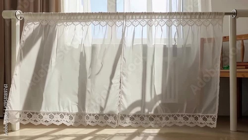 Sunlight streaming through sheer white curtains on a sunny day.