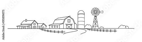 Farm buildings and windmill along a rural road landscape