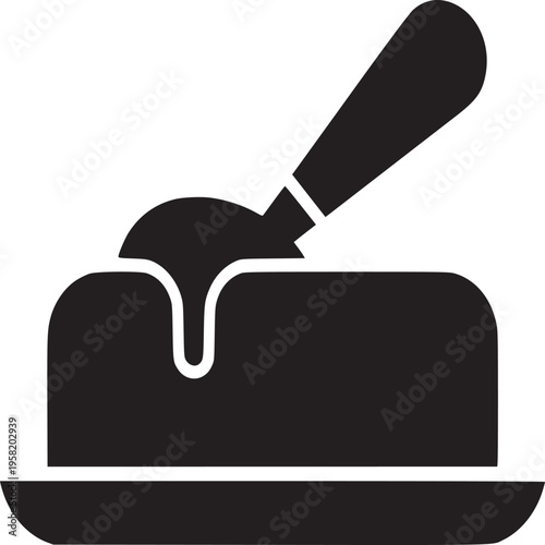 A solid black silhouette of butter on a small plate with a knife resting on top of the butter block