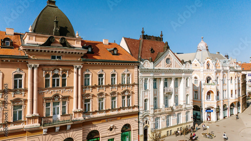 Aerial view of grand buildings with terracotta roofs bask in the sun's glow, showcasing the architectural heritage of the city., Novi Sad, Vojvodina, Serbia.