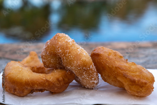Food background with freshly baked donuts on wooden surface. Street food.