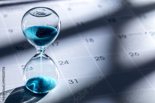 Hourglass on calendar background