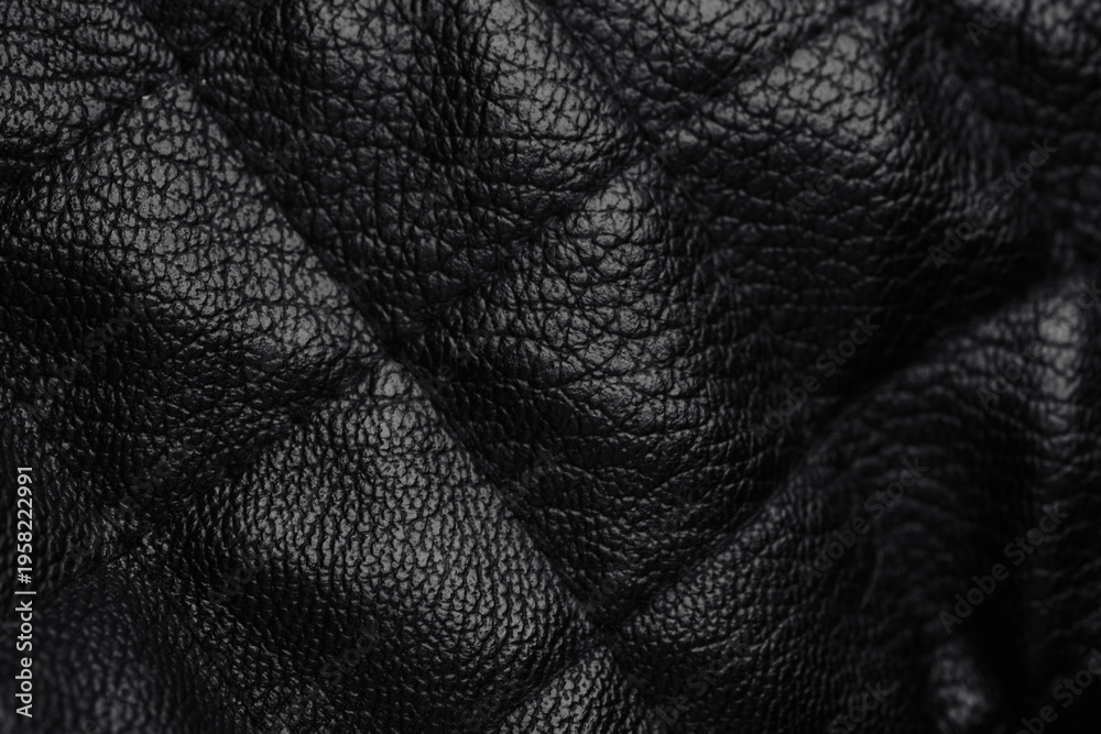 Fototapeta premium Detailed close up of dark elegant black leather surface with natural folds and distinct grain texture
