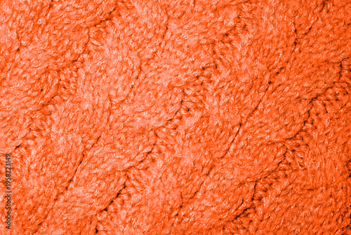 Fotografía Close-up view of soft orange knitted texture with intricate patterns and warmth