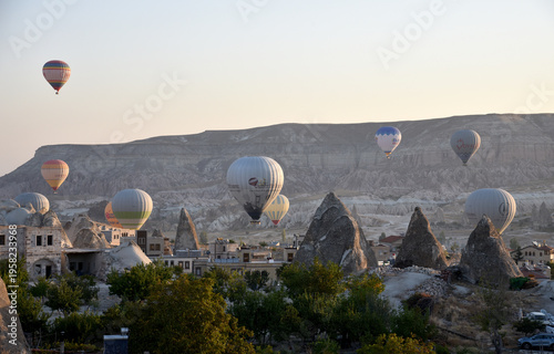 Hot air balloons flying over Cappadocia at sunrise Turkey travel concept panoramic view of Goreme valley ancient city and mountains landscape dawn outdoor adventure tourism scenery