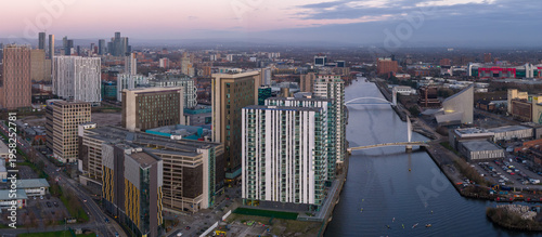 Fotografie A wide aerial panorama of the Salford Quays waterfront at dusk, featuring the Manchester Ship Canal