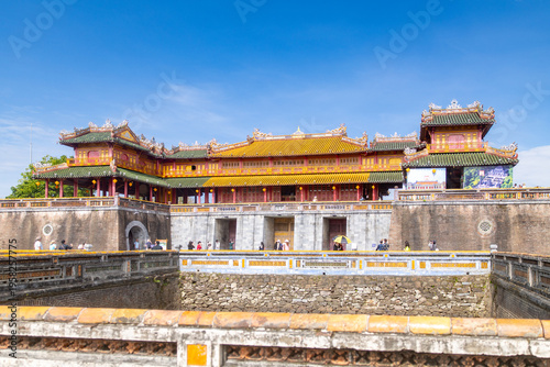 View of ancient walls and structures with elaborate roofs bathed in sunlight, a testament to history and architectural grandeur, Hue Imperial City, Hue, Vietnam.