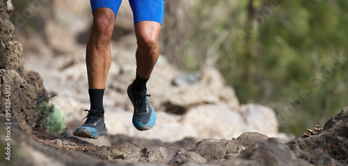 Walking or running exercise legs on rocky footpath in bright forest achievement fitness adventure and exercising in spring or summer nature motivation and inspirational activity