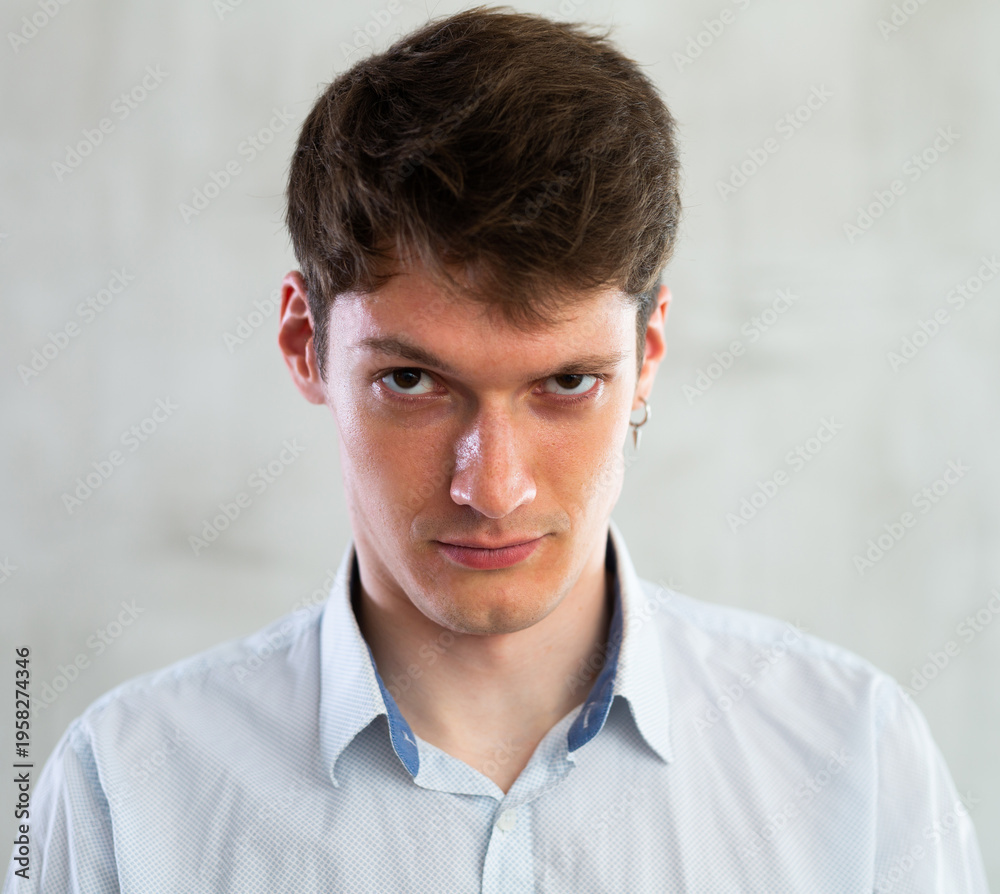 Fototapeta premium Portrait of an angry man on gray background