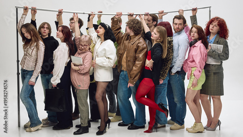 Passengers standing tightly packed holding rail in crowded public transport scene. Concept of commuter experience, comfort issues, service quality, urban transport solutions.