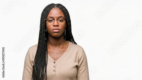 A young woman with braids gesturing a time-out sign