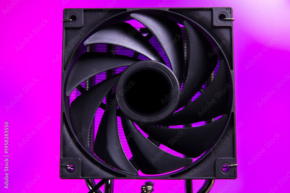 Fototapeta premium Black cooling fan with purple background used in computer setups for better airflow and temperature management during operation