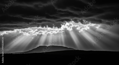 Dramatic Black and White Landscape: God Rays Piercing Through Storm Clouds