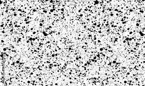 Heavy black ink splatter and dense paint spray texture on white background for grunge effect