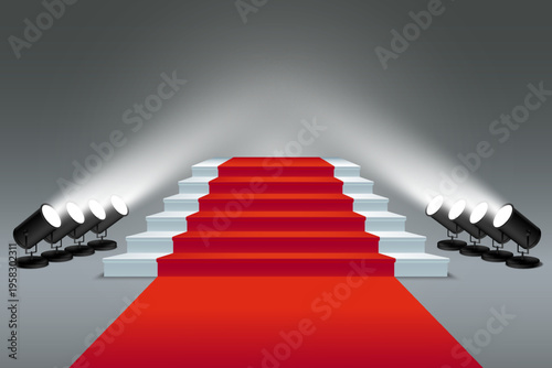 Red carpet leading up stairs with spotlights