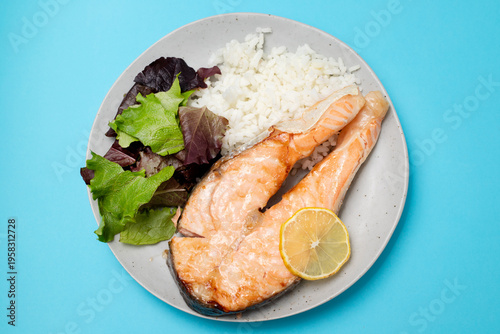 Baked salmon with boiled rice and salad