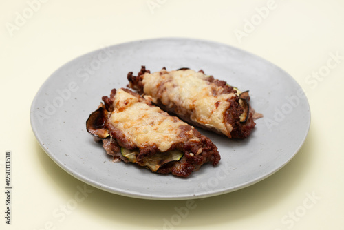 Fried ground meat with cheese and vegetables on plate