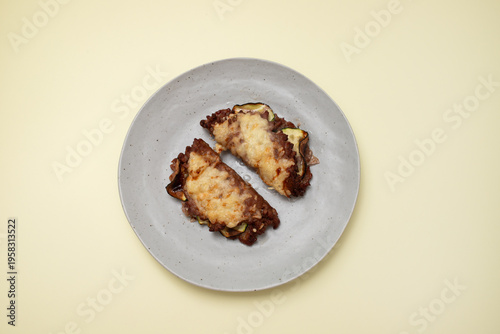 Fried ground meat with cheese and vegetables on plate