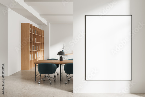 Minimal interior workspace with large blank wall poster mockup, modern furniture, wooden shelves and clean architecture illuminated by soft daylight. 3D Rendering
