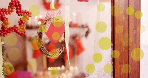 Animation of yellow dots moving over window with christmas decoration