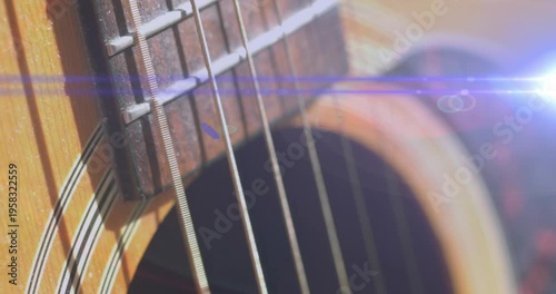 Animation of light flashing over guitar strings moving