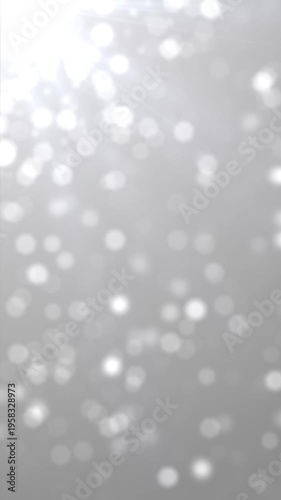 Bokeh Particles Silver Background Loop. 10 seconds loop animation of shiny particles with silver background, vertical resolution.