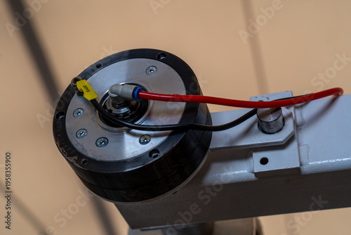 Slika na platnu Close up of industrial rotary actuator with pneumatic hose, automated machinery
