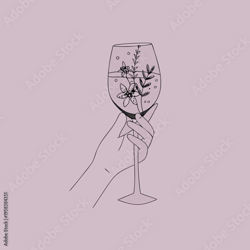 A hand delicately holds a wine glass filled with flowers and bubbles