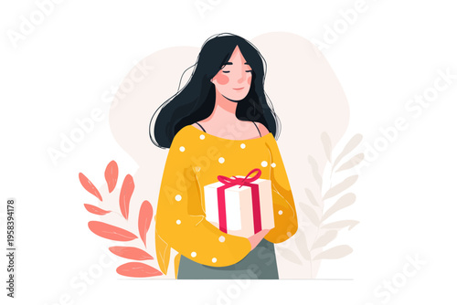 Young asian female holding gift box with delightful expression