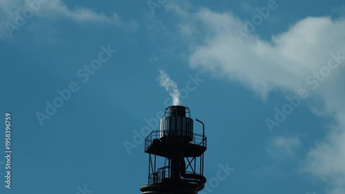 4K 59,94 fps Industrial Close-up: Factory Chimney Smoking Against Blue Sky
