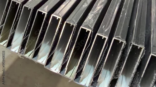 details of furniture facades made of aluminum profile. furniture production. 45-degree sawn furniture facades in production. close-up. aluminum dust.