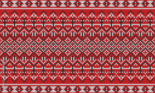 A vibrant red cross-stitch pattern in an ethnic or Native style.