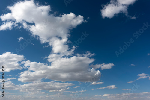 Canvas-taulu white, cottony clouds covering the horizon in the blue sky