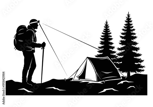 Silhouette of hiker with headlamp and trekking poles setting up camp near pine trees