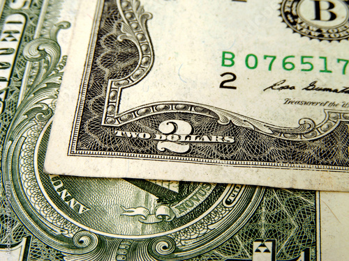A close-up of a 2 and 1 dollar bill
